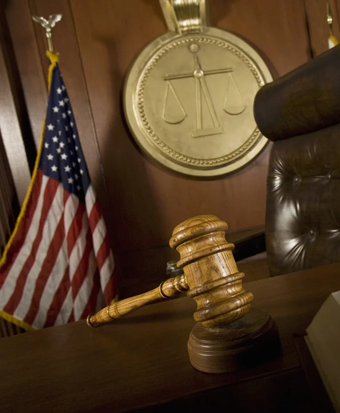 Stock criminal defense with judge chair and gavel.